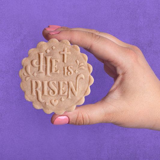 Embossed sugar cookie that says He is Risen